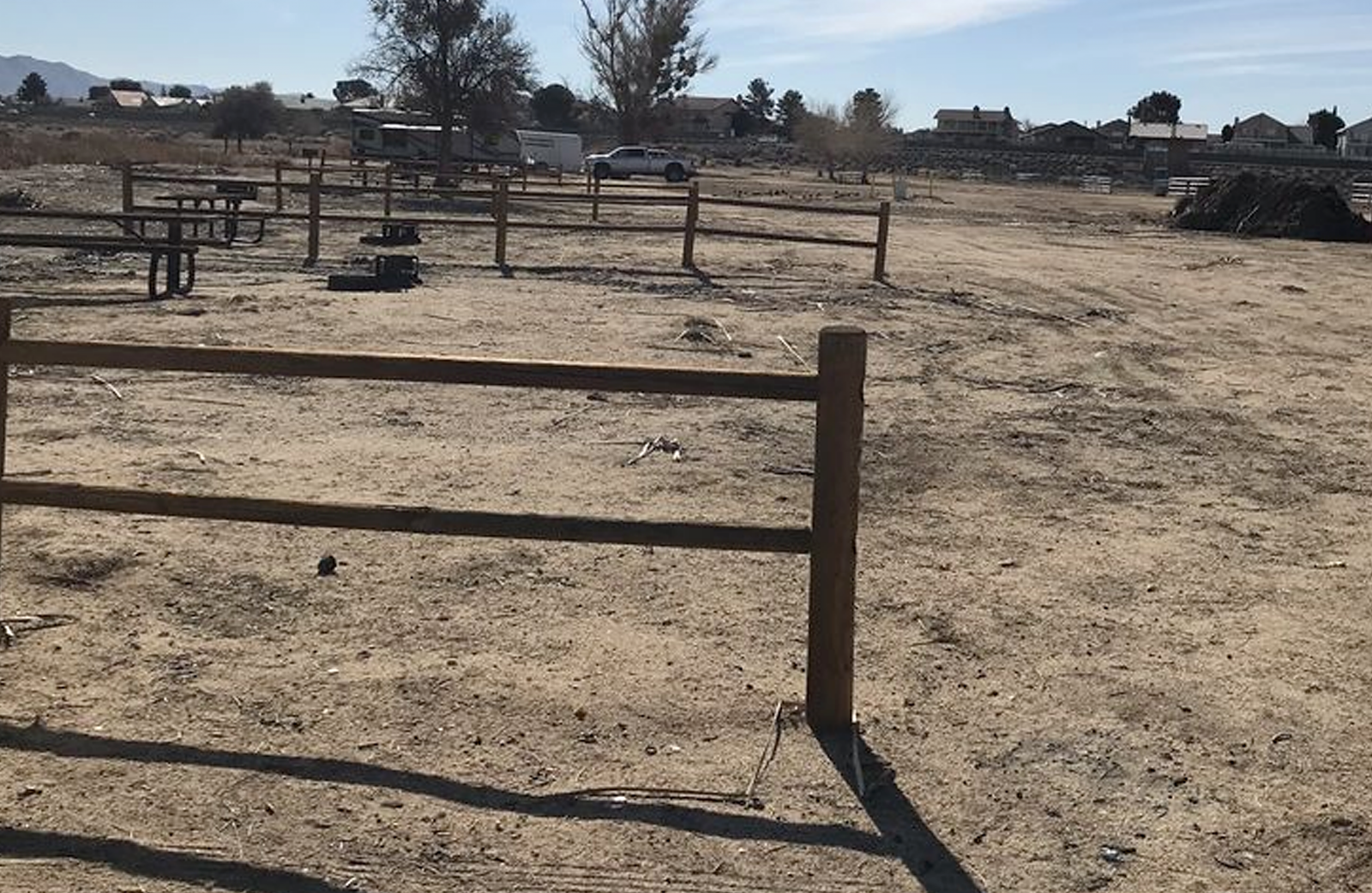 Empty dirt horse stalls at Mojave Narrows camp site.