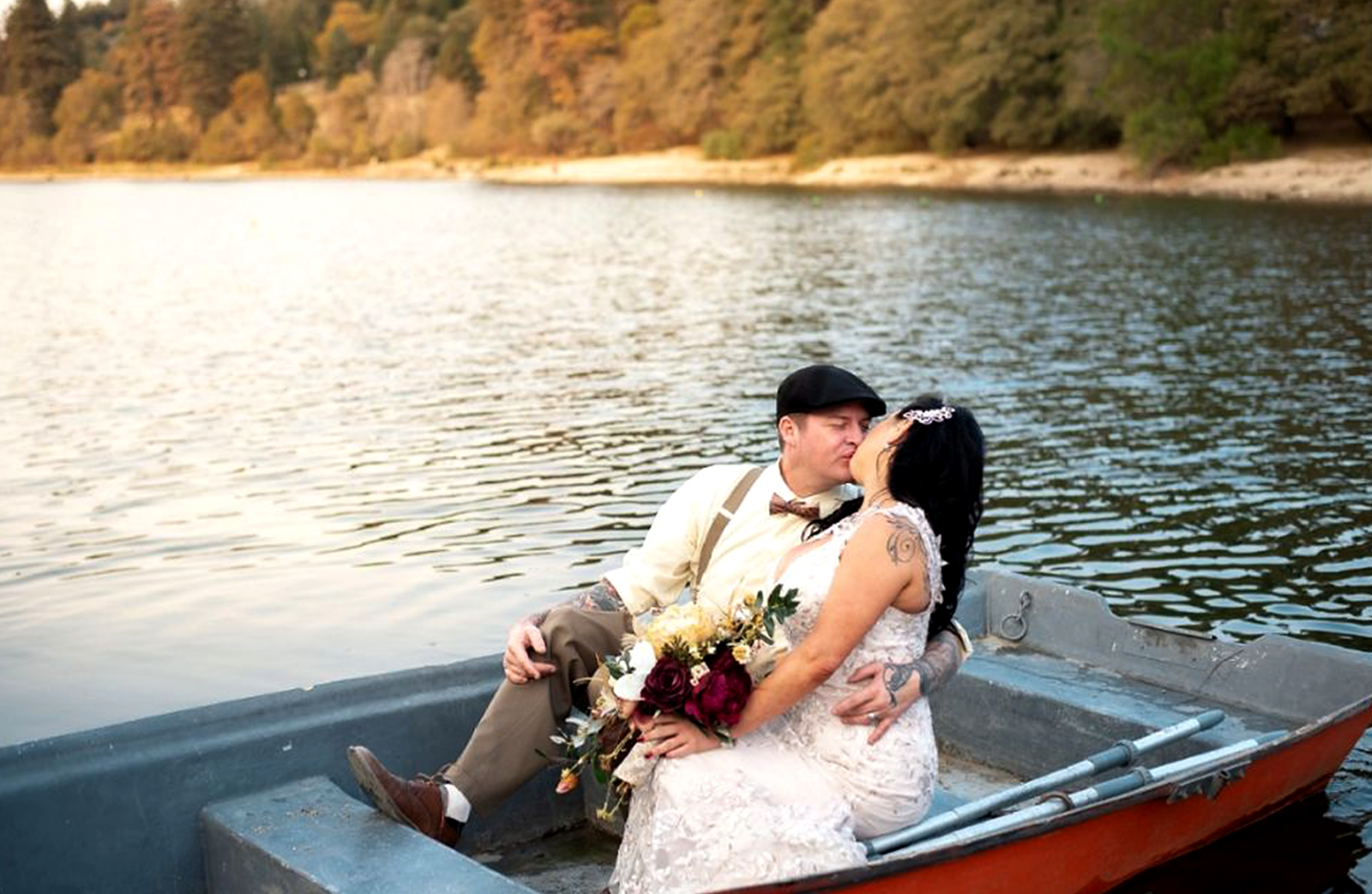 married couple kissing on a boat on a lake