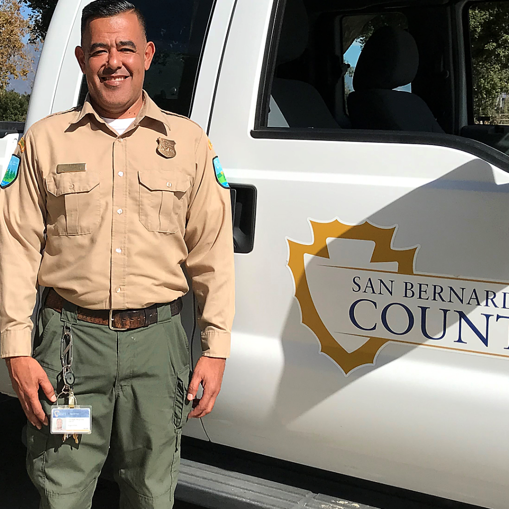 Ranger Joe from Guasti Park standing by the County truck smiling.