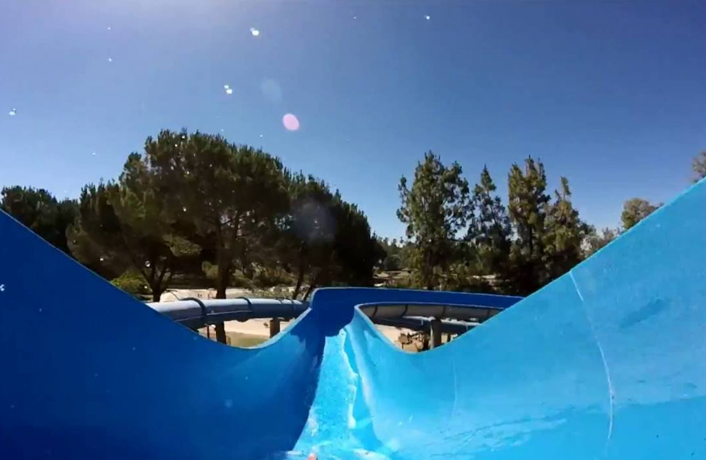Person going down a blue waterslide