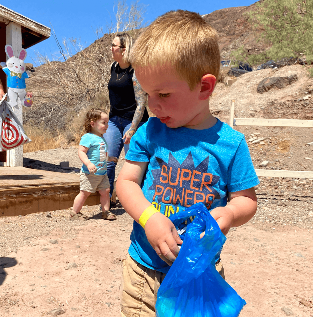 A little boy gathers Easter eggs at Calico Ghost Town in 2022.