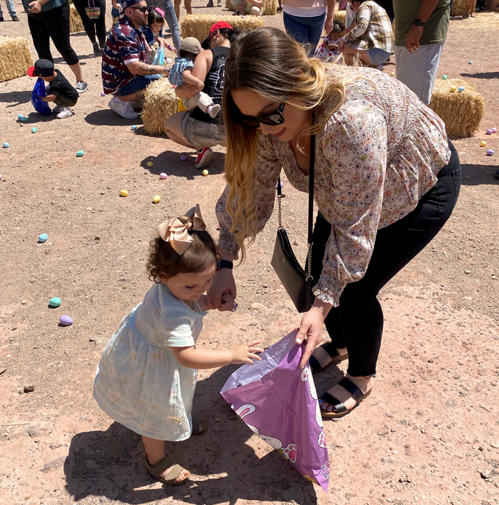 A mother assists her daughter while hunting for Easter eggs at Calico Ghost Town in 2022.