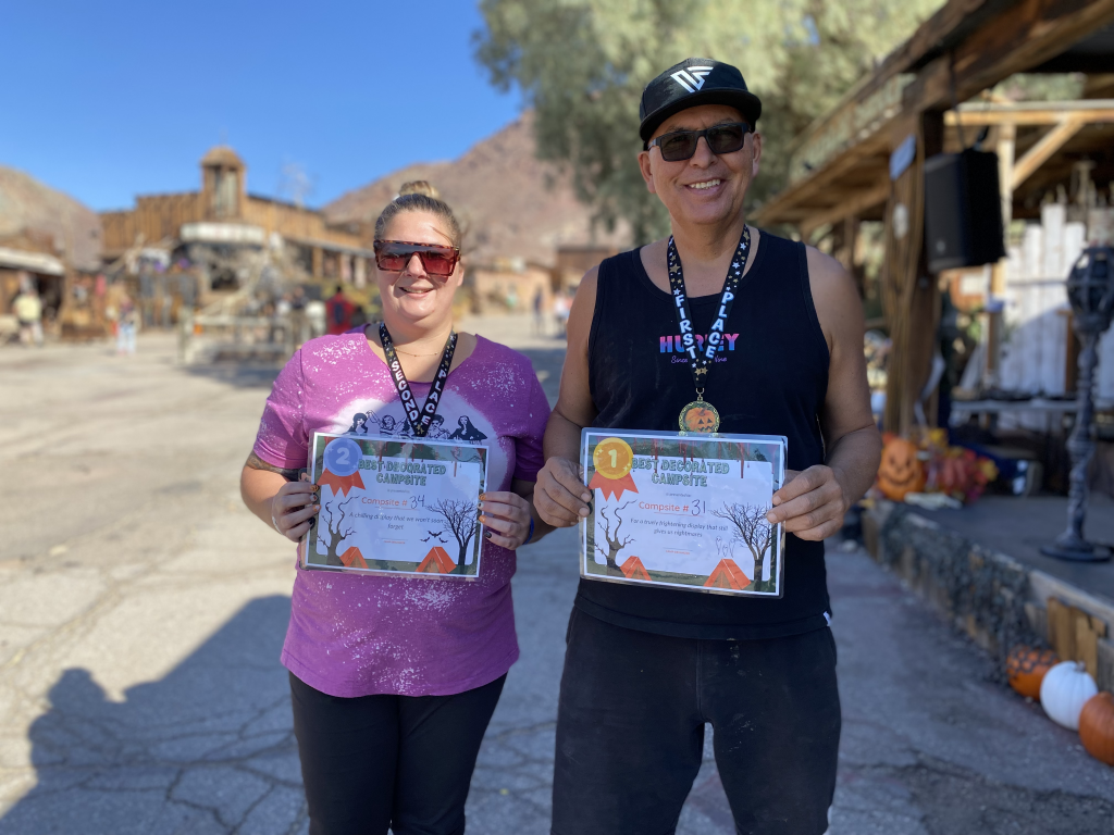 A man and woman hold a certificate