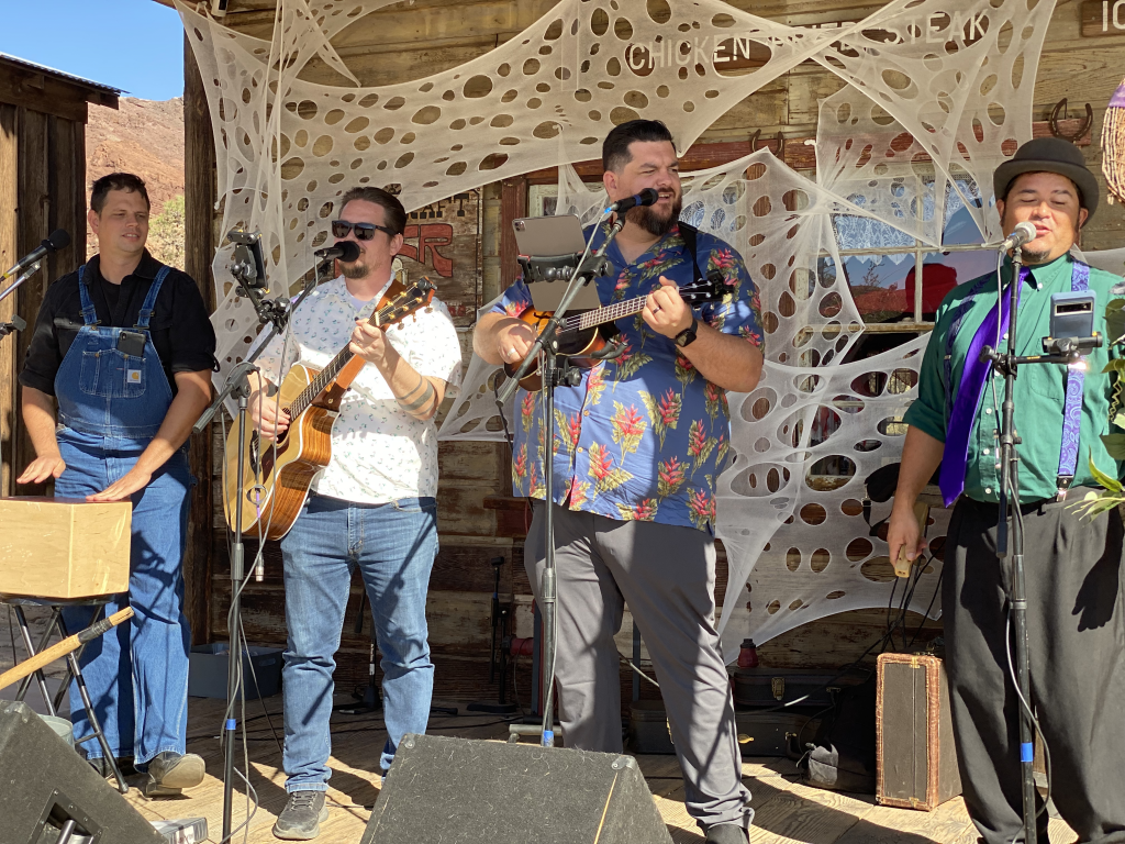 A group of male musicians singing in a band