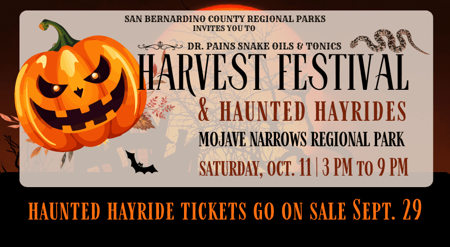 A wicked pumpkin with harvest flowers underneath. In ornate font reads Harvest Festival & Haunted Hayrides, Mojave Narrows Regional Park, Saturday, Oct. 11, 3 p.m. to 9 p.m. and below Haunted Hayride Tickets go on sale Sept. 29. There is an illustration of a snake at top and a bat on the bottom.