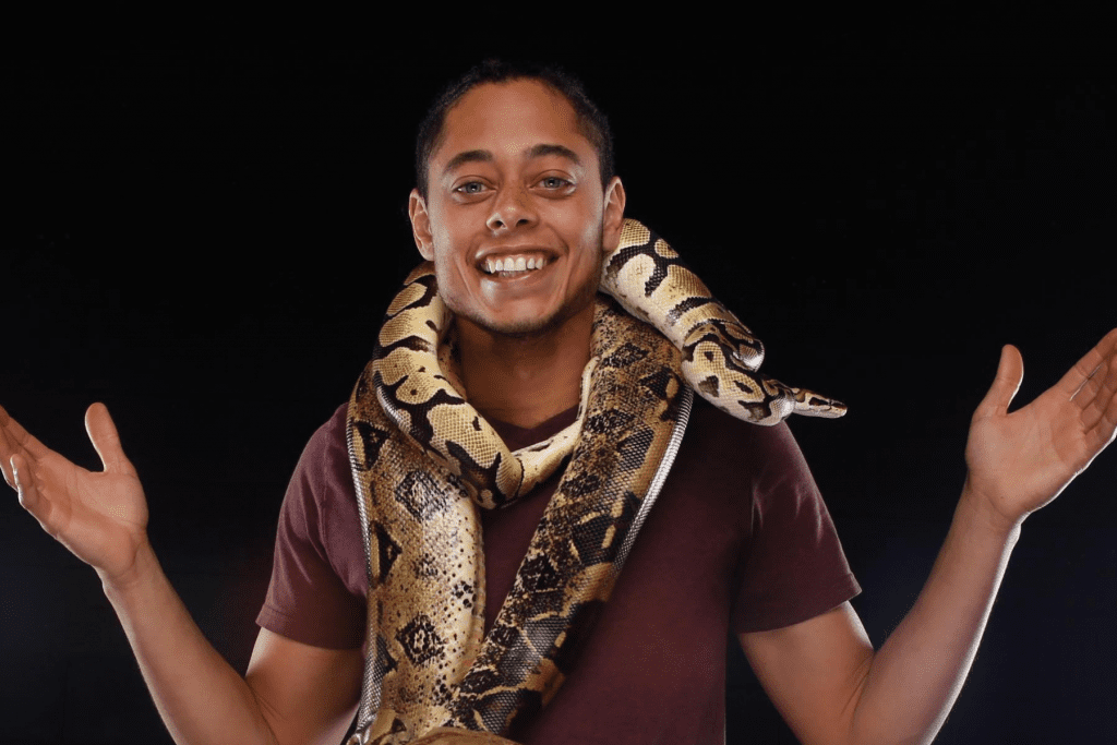 A man with a boa constrictor around his neck.