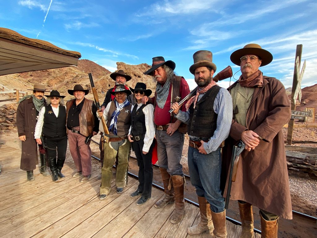 The Calico Mountain Volunteer Gunfighters stand at the Odessa train station at Calico Holiday Fest.