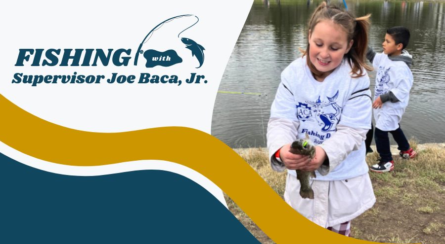 A young girl smiles while holding a fish and a young boy holds a fishing pole behind her near a lake. The word Fishing with Supervisor Joe Baca, Jr. is on the left.