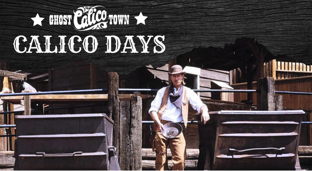 A man dressed in Western wear stands while holing a mining pan at Calico Ghost Town.