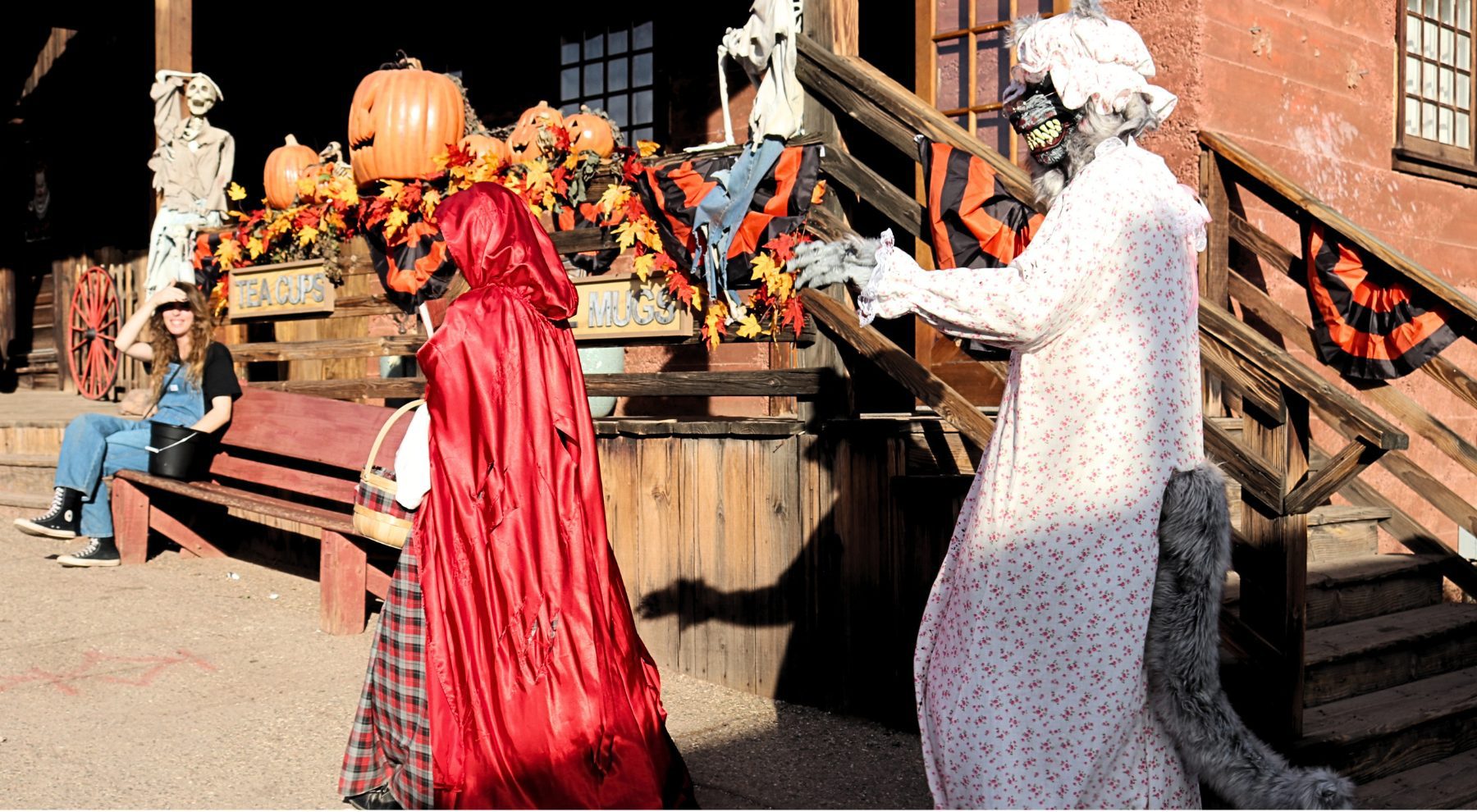 Two people dressed in Halloween costumes as the Big Bad Wolf and Little Red Riding Hood walk through Calico Ghost Town.