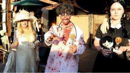 Three young people dressed in Halloween costumes at Calico Ghost Town.