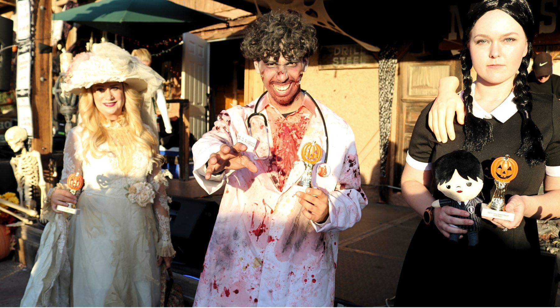 Three young people dressed in Halloween costumes at Calico Ghost Town.